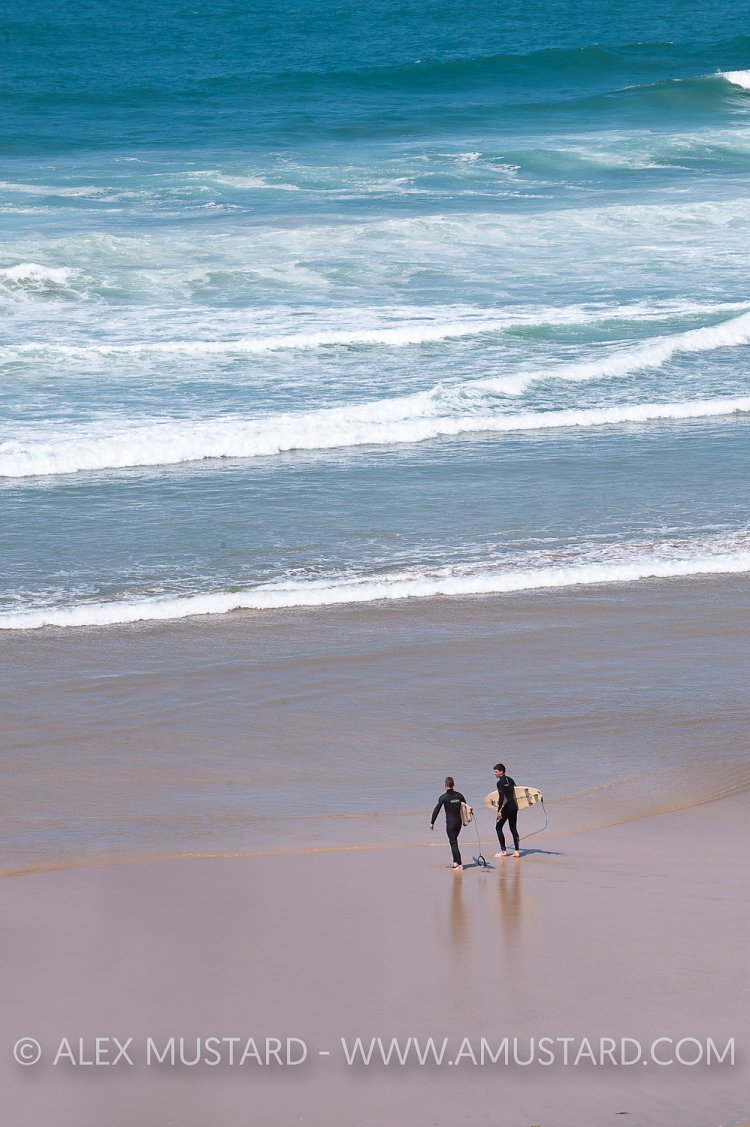 Surfers Head To Sea. Cornwall, UK