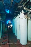 DIver and cylinders on USS Kittiwake. Cayman Islands.
