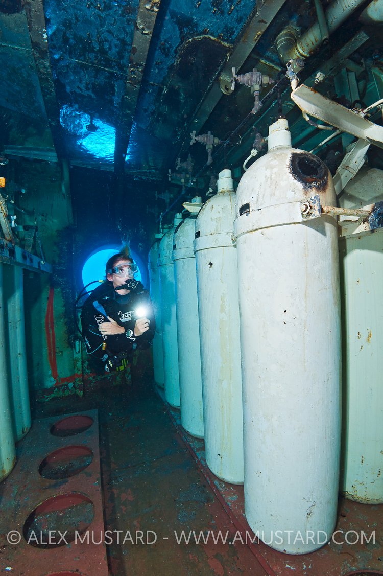 DIver and cylinders on USS Kittiwake. Cayman Islands.