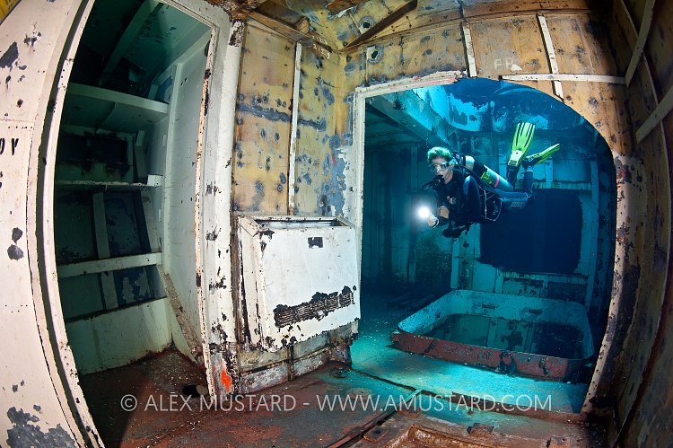 DIver in forward holds of USS Kittiwake. Cayman Islands.