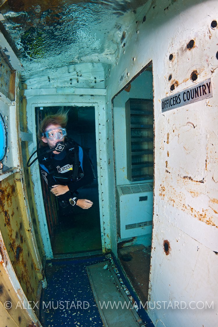 Diver inside USS Kittiwake wreck. Cayman Islands.
