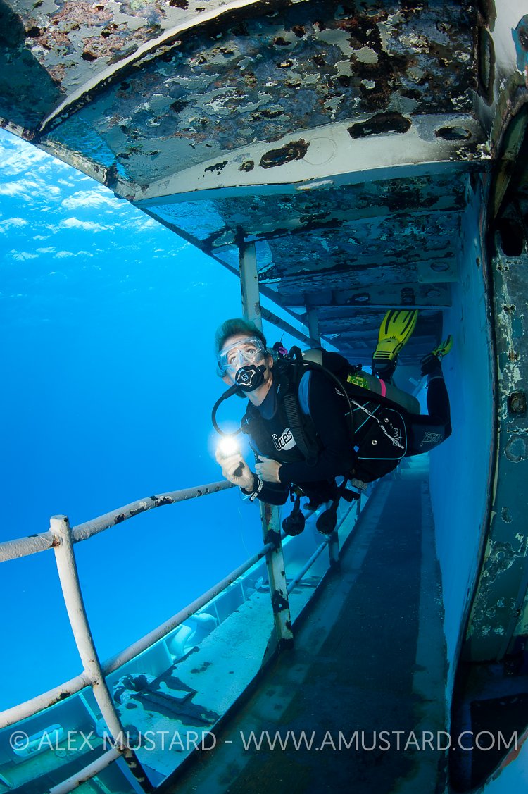 Diver explores USS Kittiwake wreck. Cayman Islands