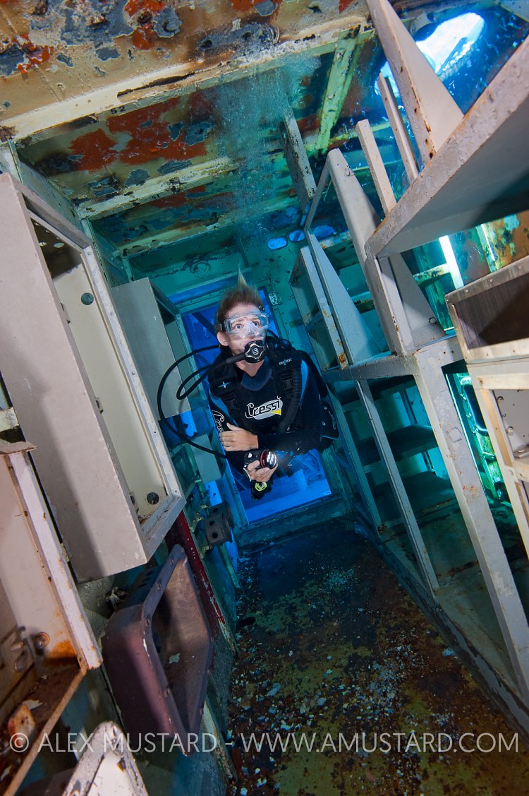 Diver inside USS Kittiwake wreck. Cayman Islands.