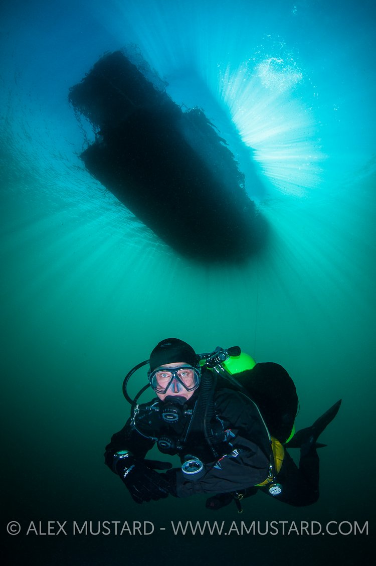 Diver Beneath Boat. Canada