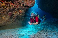 Diver In Coral Caverns. Cayman Islands