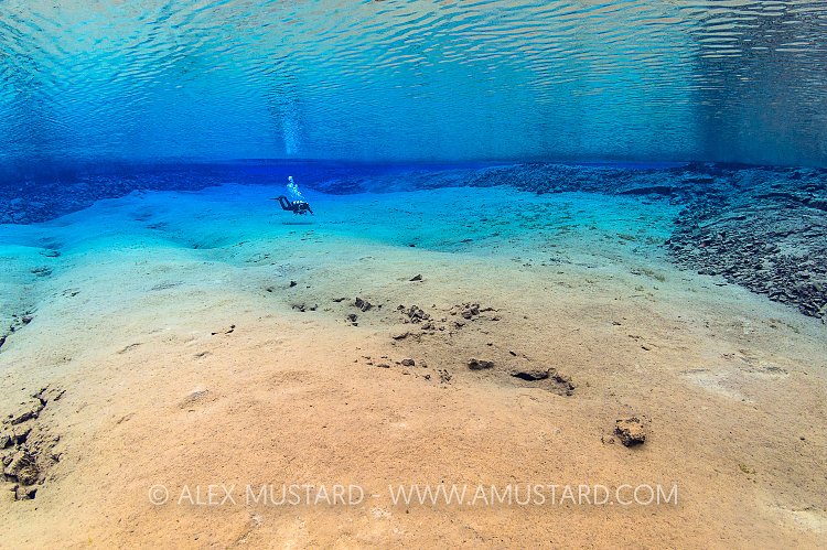A diver in Blue Lagoon, Silfra. Iceland