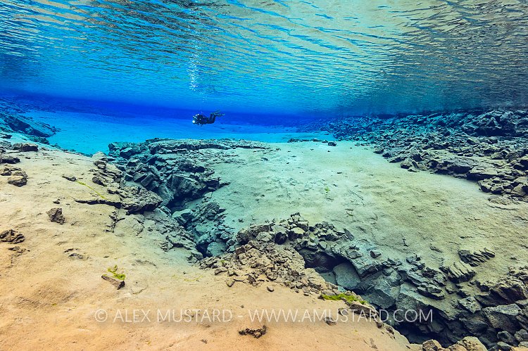 A diver in Blue Lagoon, Silfra. Iceland