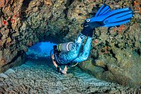 Diver In Coral Cavern. Cayman Islands