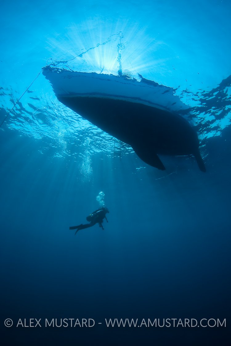 Diver And Yacht. Sardinia, Italy.