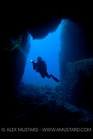 Diver in sea cave. Sardinia.