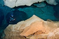 Diver Approaches Underwater Cavern. Sardinia
