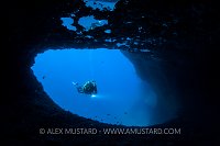 Diver Enters Cave. Sardinia, Italy.