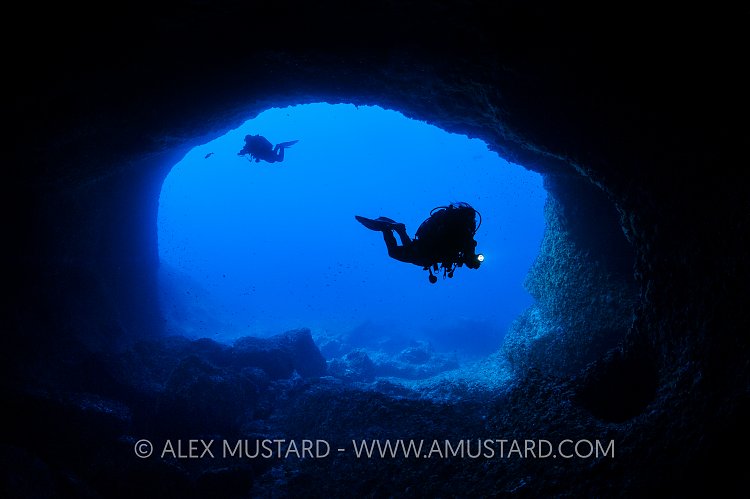 Divers Enter Cave. Sardinia, Italy.