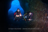Divers In Cave. Sardinia, Italy