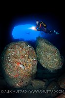 Divers In Nereo's Cave. Sardinia, Italy.