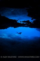 Diver And Cave. Sardinia, Italy.