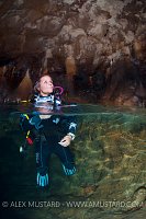 Diver Surfaces Inside Cave. Sardinia, Italy.