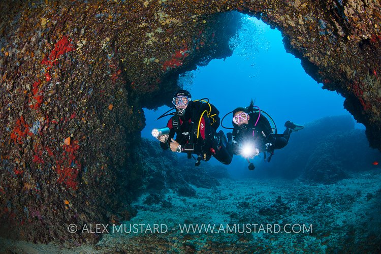 Divers Enter Cave. Sardinia, Italy.